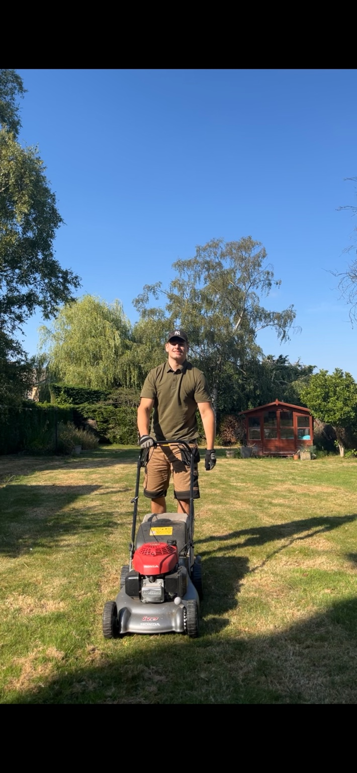 John from JSC Garden Services with a lawn mower